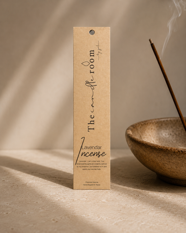 Lavender charcoal incense in kraft paper packaging beside a smoking incense stick