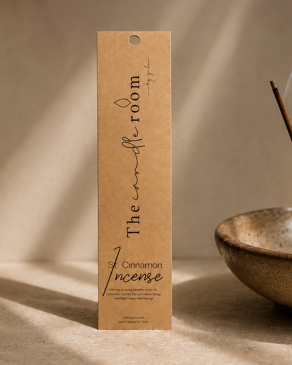 St. Cinnamon charcoal incense in kraft paper packaging, stick burning in a ceramic bowl